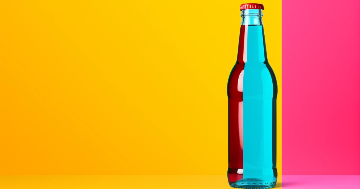Duotone glass soda bottle © History Oasis Glass soda bottle split red and blue against yellow and pink