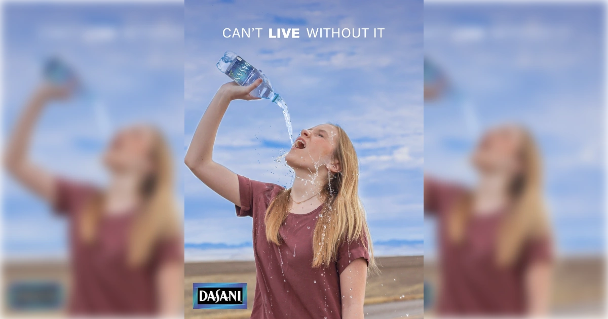 Dasani ad with blonde woman pouring bottled water into her mouth