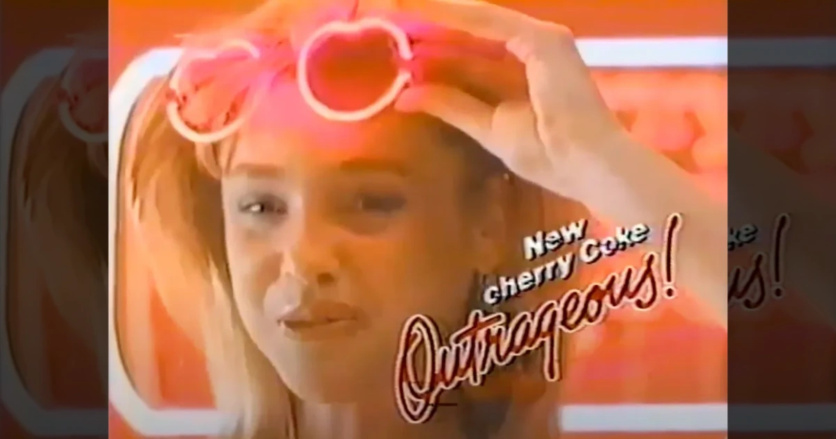 Cherry Coke Outrageous TV commercial still, girl wearing cherry sunglasses