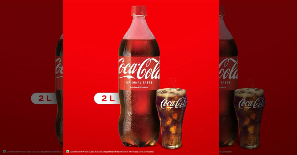 The Coca-Cola Company Coca-Cola 2-liter plastic bottle next to a glass of Coke with ice