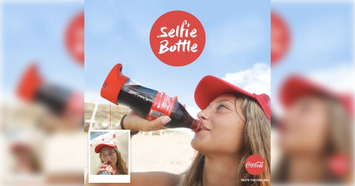 The Coca-Cola Company woman drinking from Coca-Cola selfie bottle with camera base at the beach