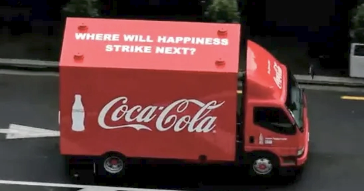 Red Coca-Cola Happiness Truck reading Where will happiness strike next
