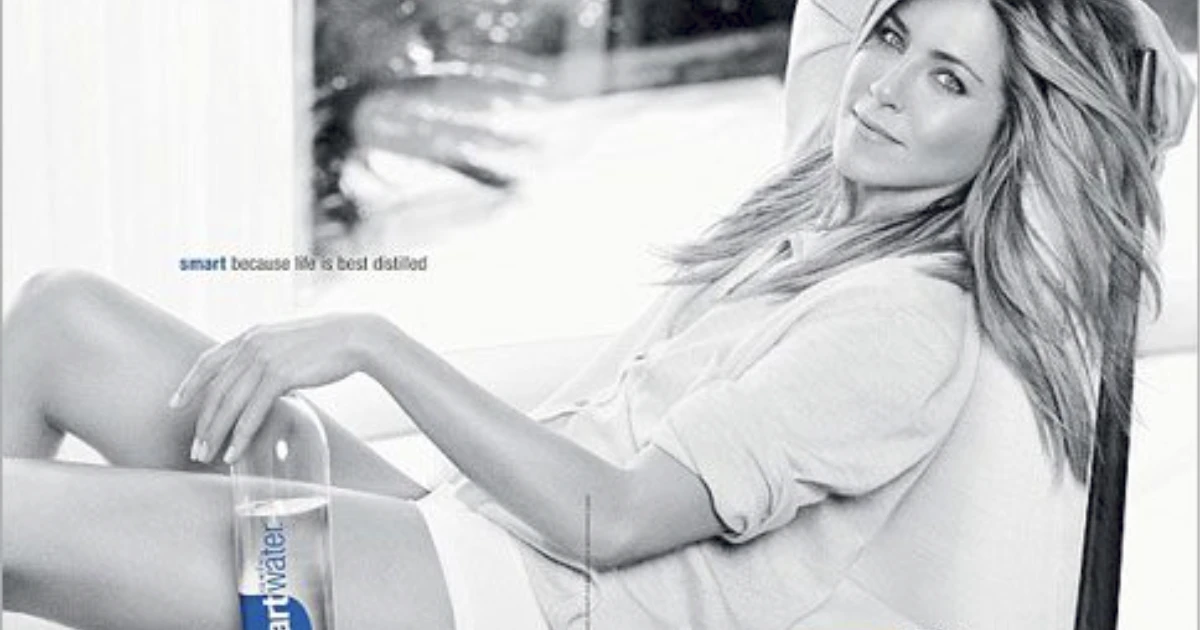The Coca-Cola Company Smartwater print ad with Jennifer Aniston reclining beside a bottle