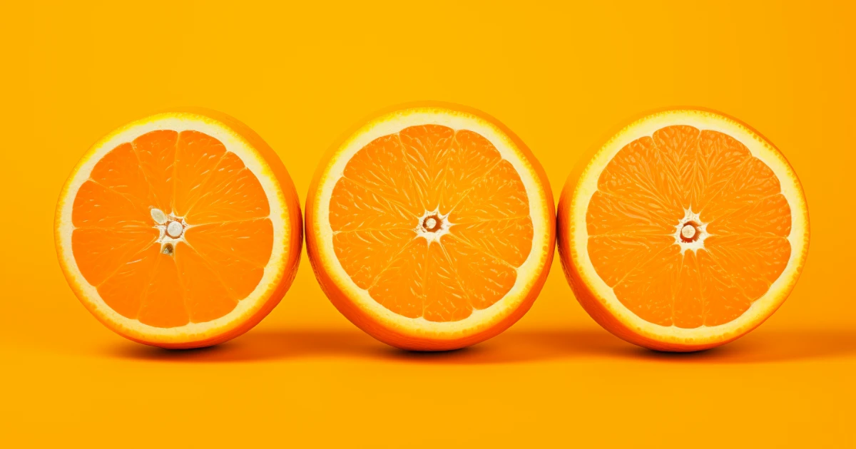 Halved oranges © History Oasis Three halved oranges lined up against a bright orange background