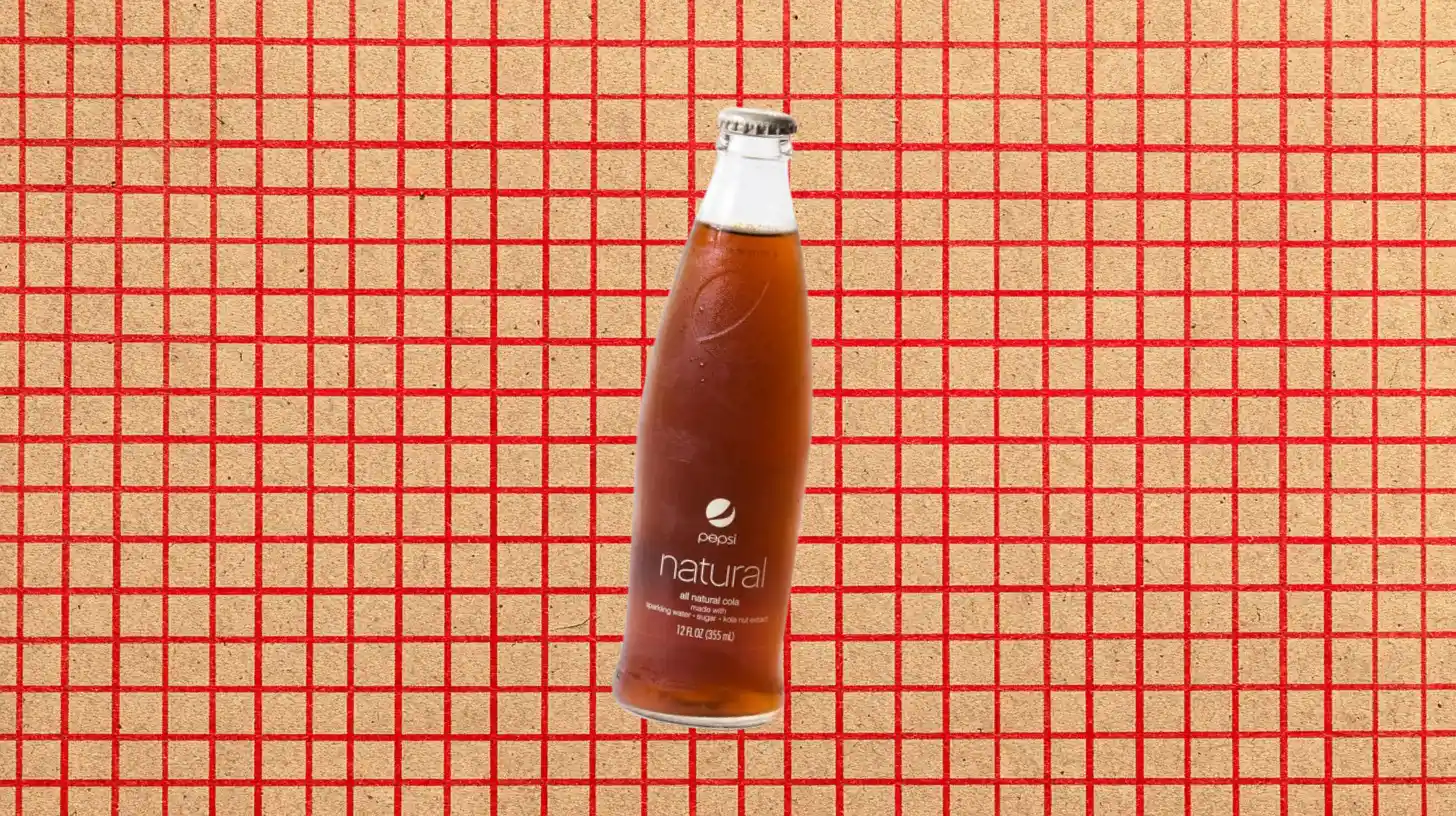 Pepsi Natural glass bottle of all-natural cola on red grid background