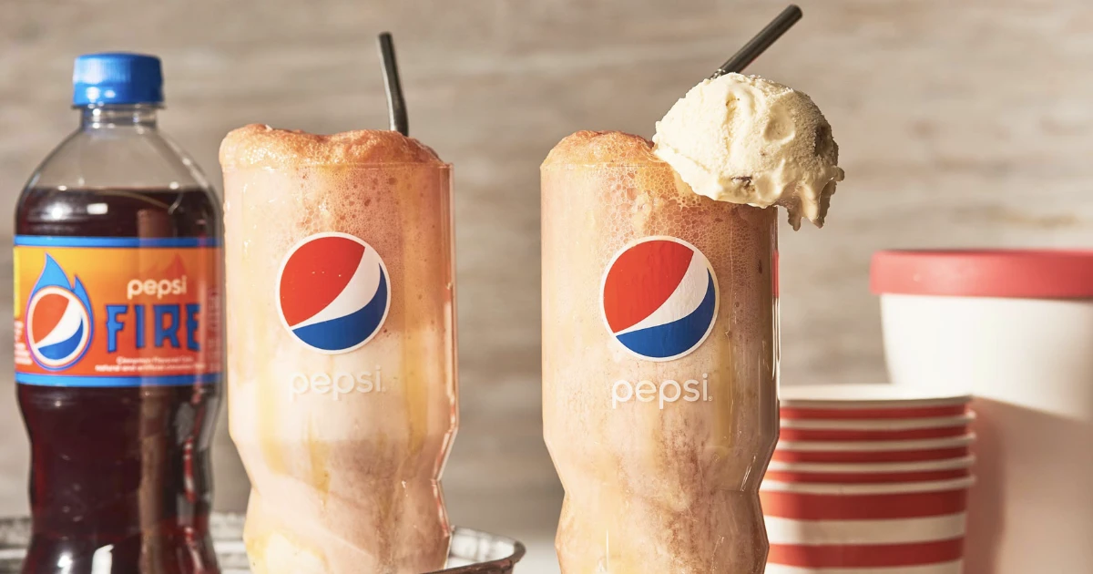 Pepsi Fire bottle beside two cola floats topped with ice cream
