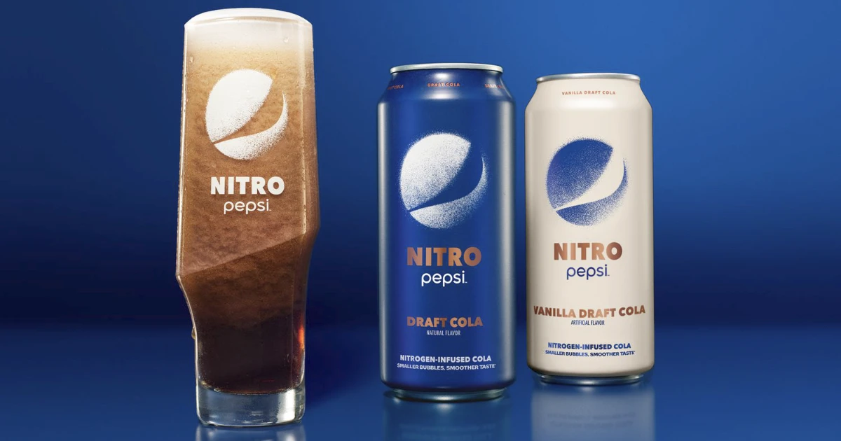 Nitro Pepsi draft cola cans beside foamy poured glass