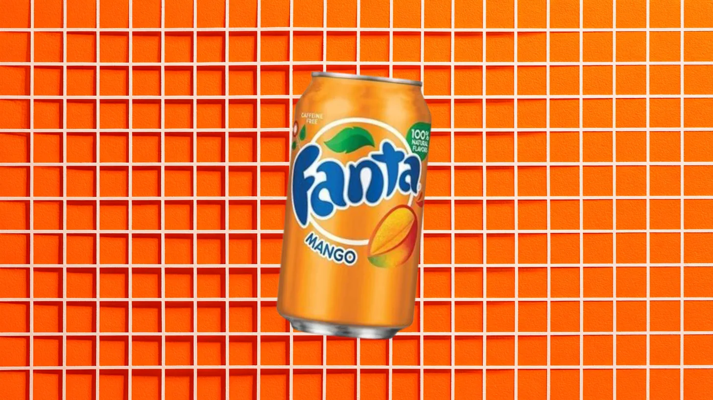 The Coca-Cola Company Fanta Mango orange soda can on an orange tile background