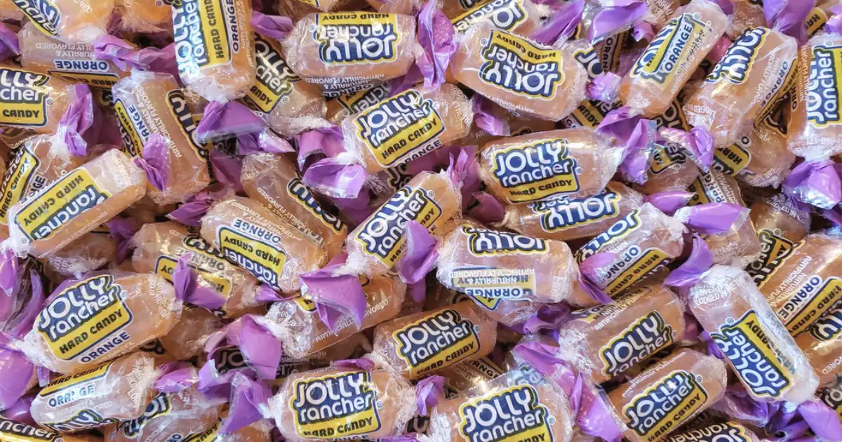 The Hershey Company Jolly Rancher Orange hard candy wrappers piled together