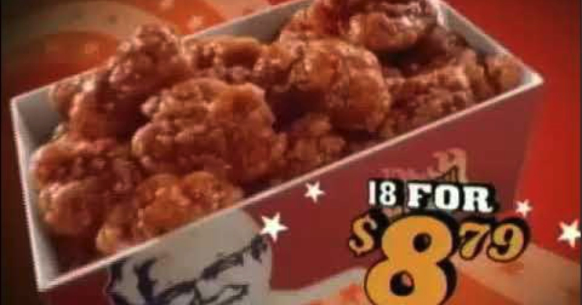 Grainy KFC television ad still showing a box of hot wings