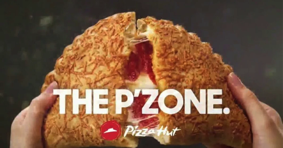Pizza Hut Hands pulling apart a cheesy Pizza Hut P'Zone calzone with marinara filling