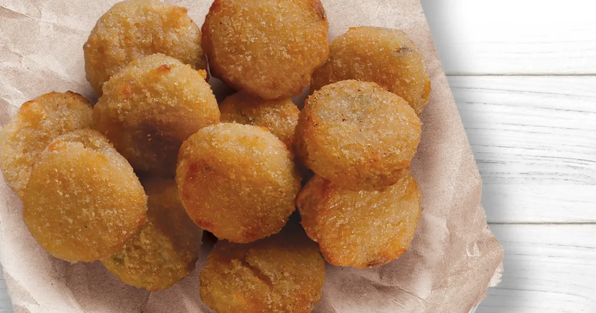 Pizza Hut Pizza Hut Quepapas breaded jalapeno cheese potato bites on parchment paper