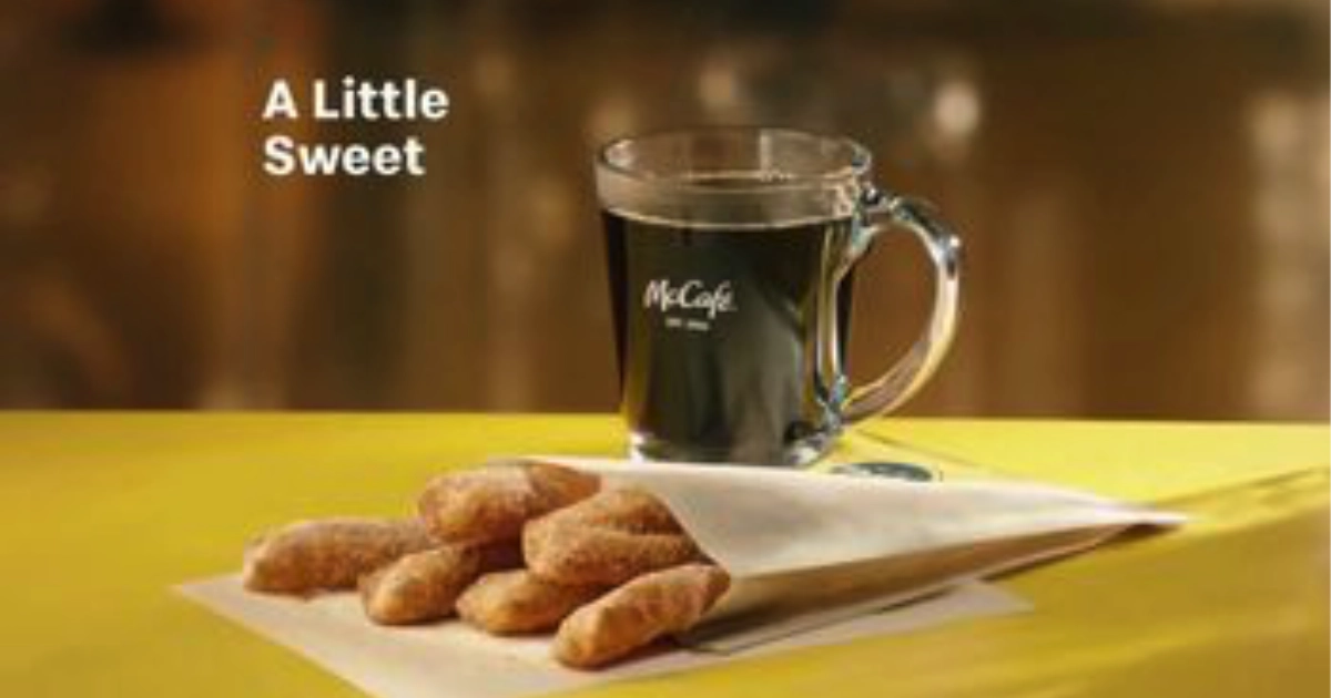 McDonald’s Donut Sticks in paper bag with McCafé coffee mug
