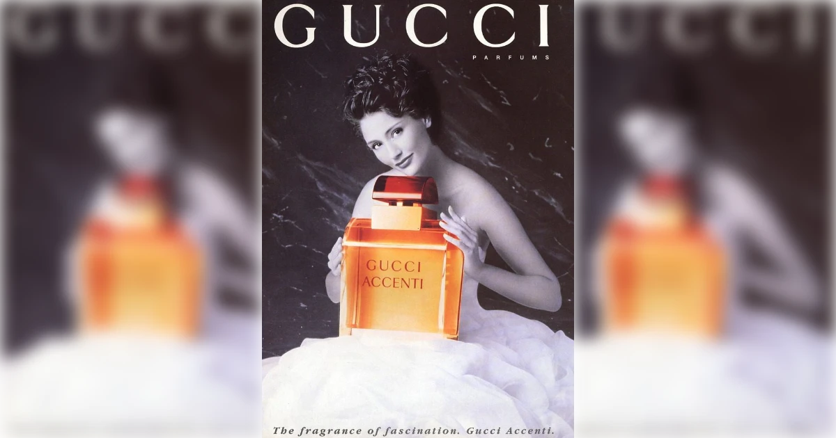 Gucci Accenti ad with model holding amber square perfume bottle