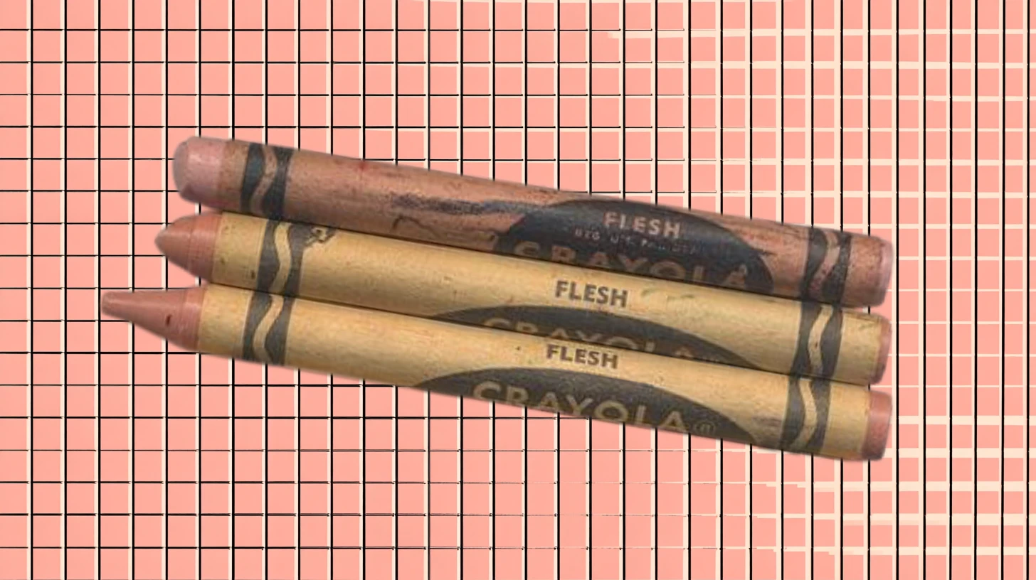 Three vintage Crayola Flesh crayons with tan wrappers and peach tips