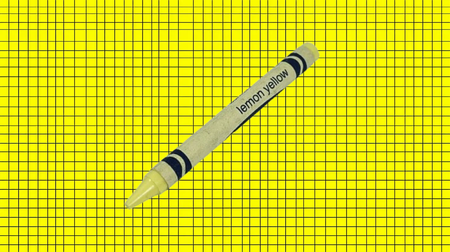 Crayola Lemon Yellow crayon with pale yellow tip on yellow grid