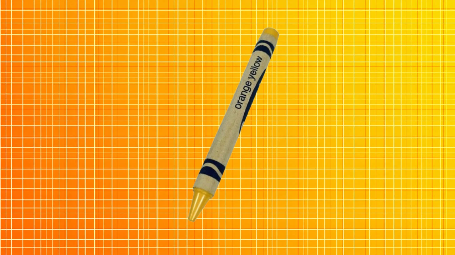 Crayola Orange Yellow crayon with golden yellow tip on orange grid