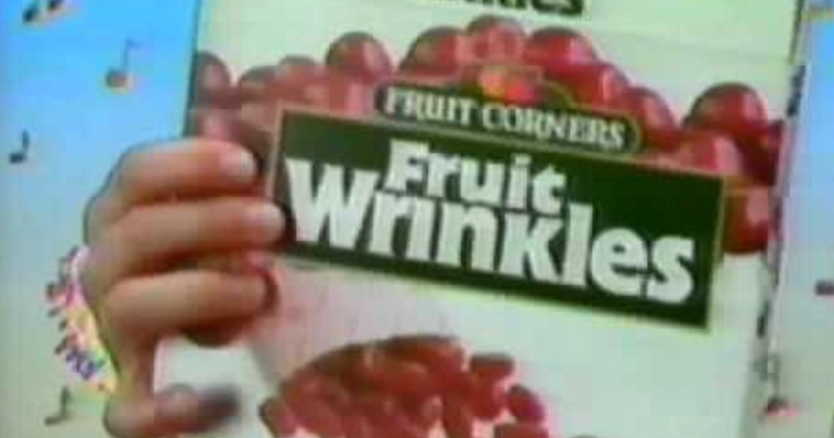 Betty Crocker Child's hand holding a Fruit Corners Fruit Wrinkles box