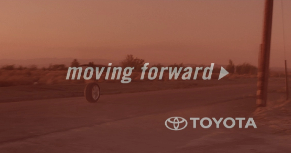 Toyota Toyota moving forward tagline over a desert road at sunset