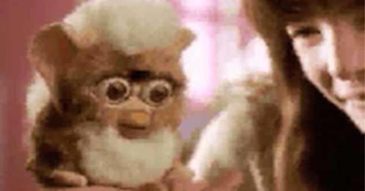Furby Child holding brown and white original Furby electronic toy