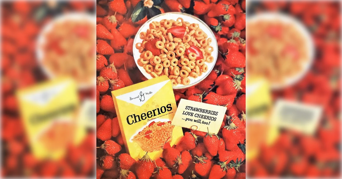 General Mills Vintage yellow Cheerios box and bowl surrounded by fresh strawberries