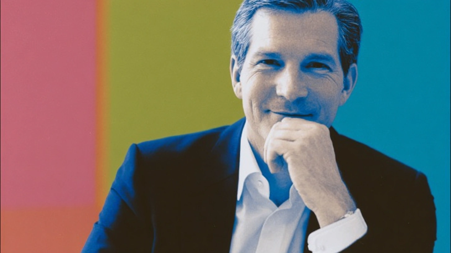 Philipp Navratil portrait, Nestlé CEO, smiling in dark suit with hand on chin