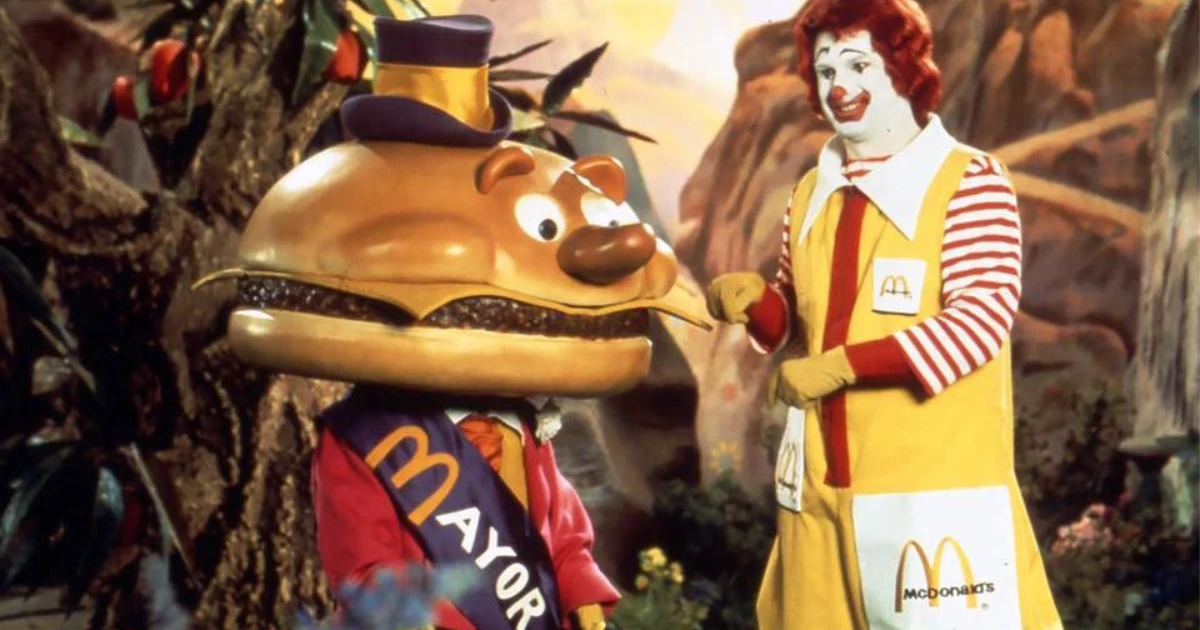 Mayor McCheese mascot, a cheeseburger head in a top hat, beside Ronald McDonald