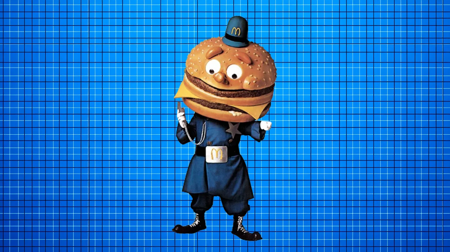 Officer Big Mac mascot with a Big Mac burger head in a blue police uniform