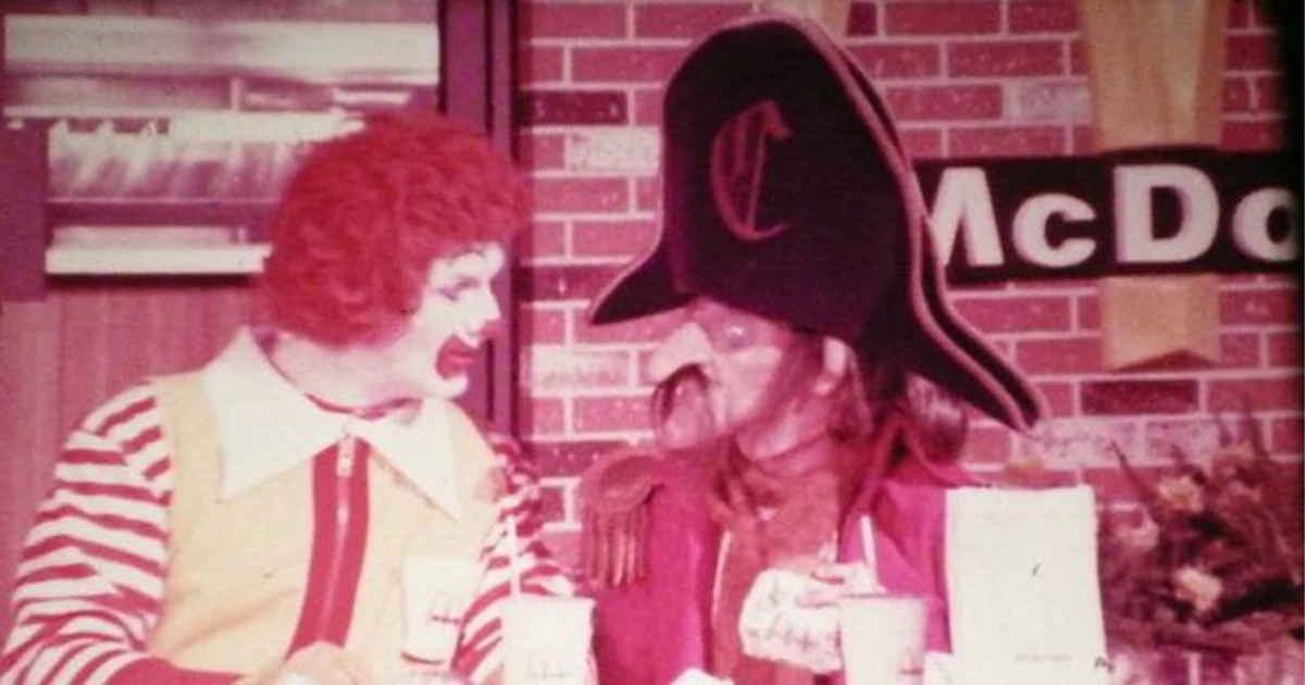 Captain Crook, McDonald's pirate mascot in a black hat, sitting with Ronald McDonald