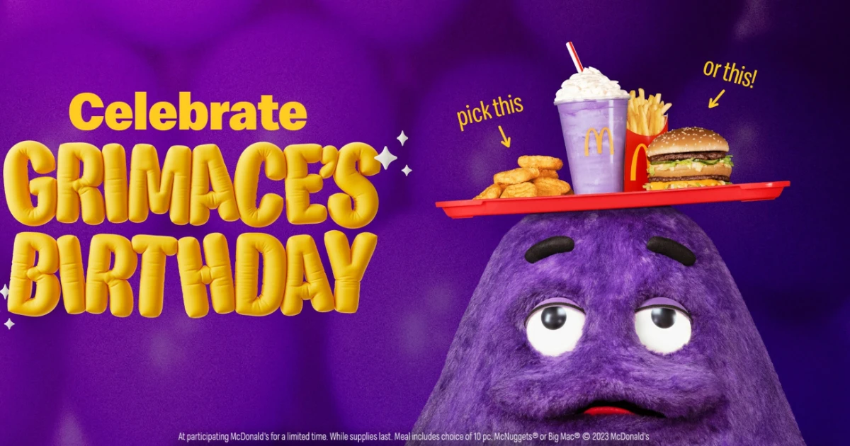 Grimace, the purple McDonald's mascot, balancing a birthday meal tray on his head