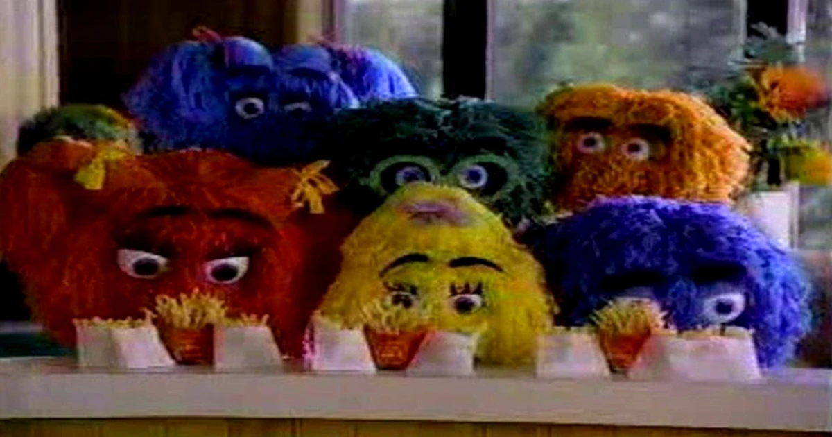 The Fry Kids, McDonald's colorful pom-pom mascots, eating cartons of French fries