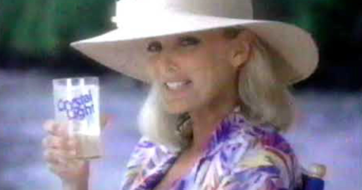 Woman in a white sun hat holding a Crystal Light glass, vintage commercial still