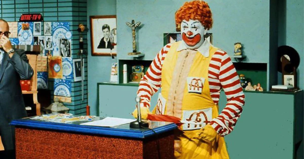 McDonald's Ronald McDonald in yellow jumpsuit and red striped sleeves on a TV set