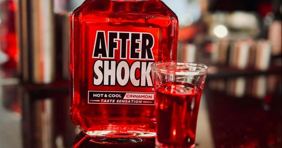 Aftershock Red Aftershock cinnamon liqueur bottle beside a filled shot glass