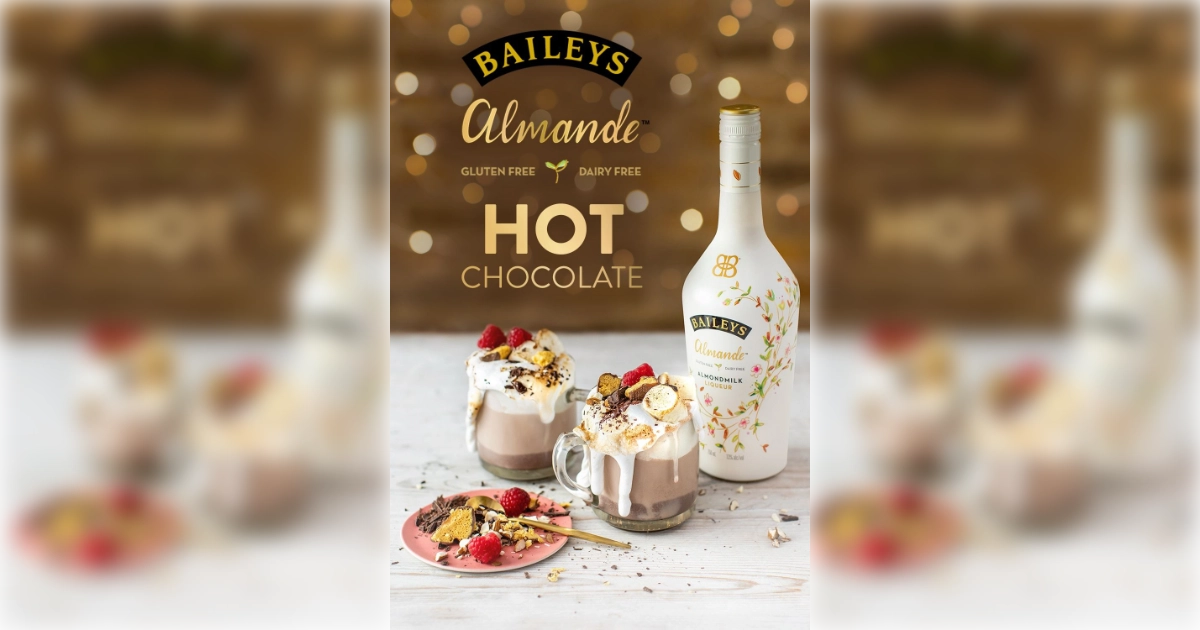 Diageo Baileys Almande bottle with hot chocolate mugs and raspberries