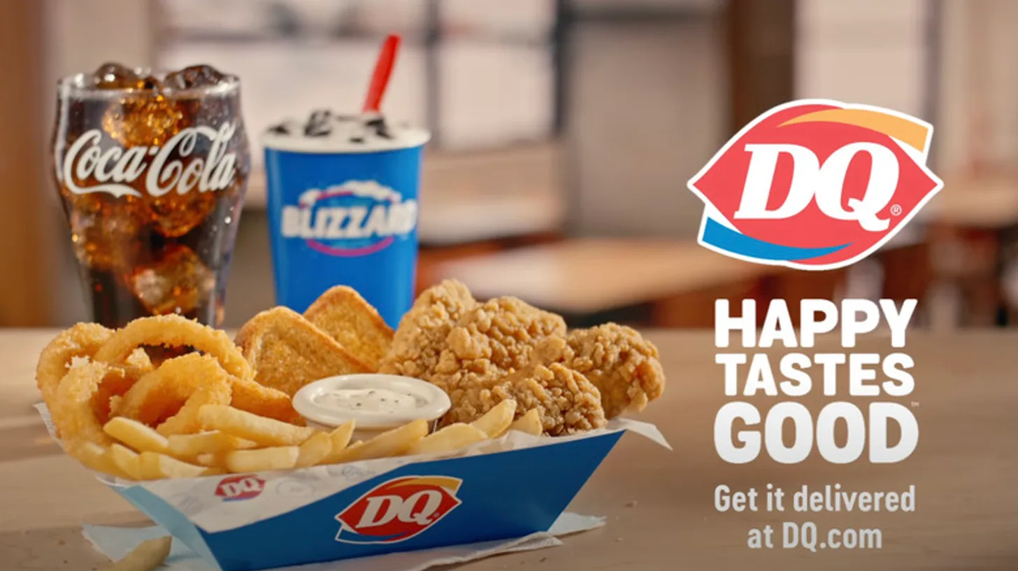 The tagline on a chicken strip basket key visual / Dairy Queen Happy Tastes Good tagline beside a Dairy Queen chicken strip basket, Blizzard cup and soft drink