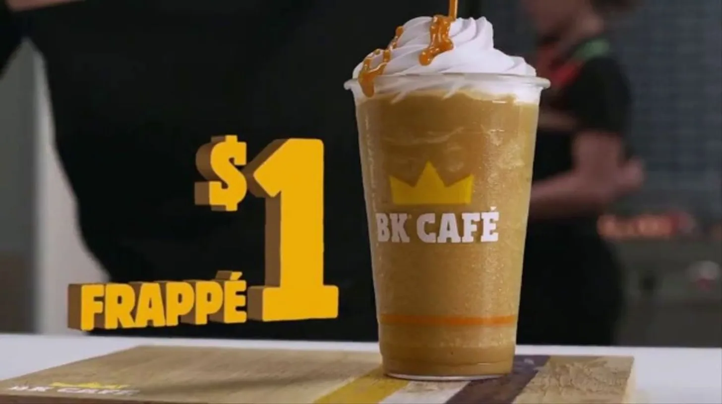 A later, BK Café-era $1 frappé ad — the drink returned under new branding before fading for good — Burger King A one-dollar BK Café frappé topped with whipped cream and caramel drizzle in a Burger King ad