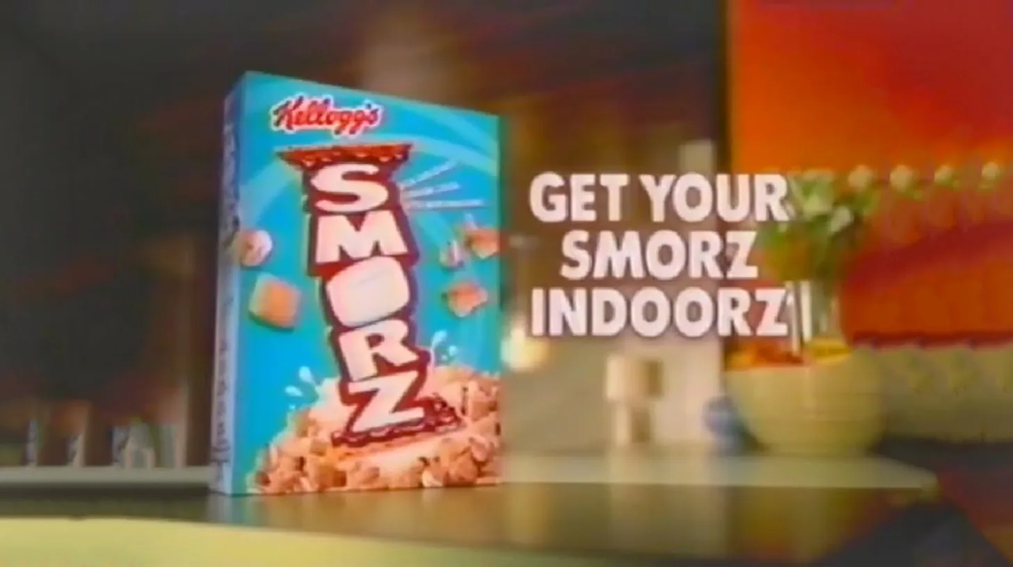Kellogg's Smorz cereal box on a kitchen counter beside the slogan Get Your Smorz Indoorz in the 2004 TV commercial