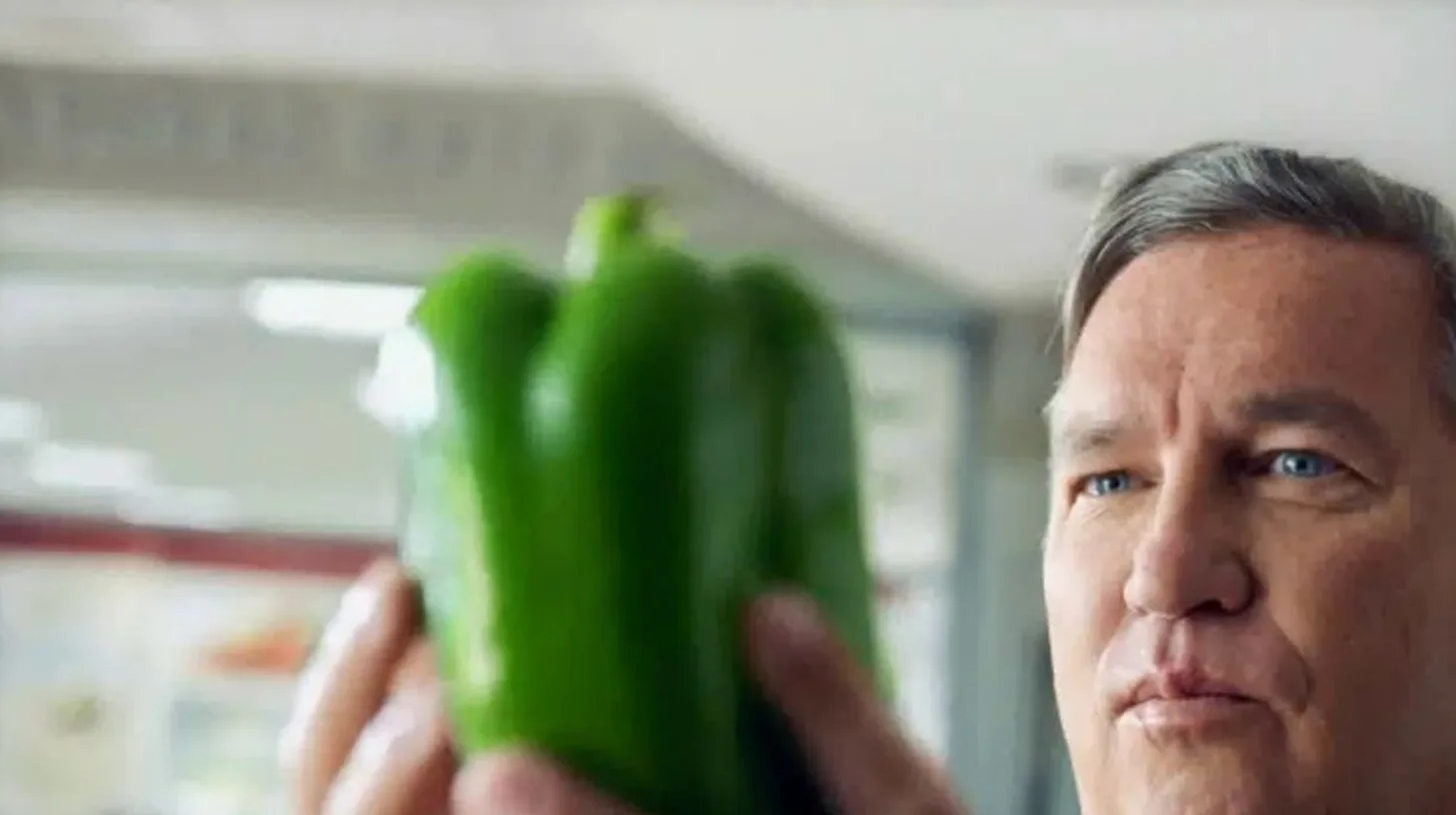 Chief Ingredient Officer Sean Muldoon in the Not Just a Slogan spot / Papa John's Sean Muldoon inspecting a green bell pepper in the Not Just a Slogan commercial