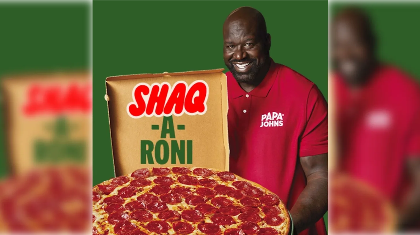 Shaquille O'Neal with the Shaq-a-Roni / Papa John's Shaquille O'Neal holding a Shaq-a-Roni pizza box and pepperoni pizza in a Papa John's ad