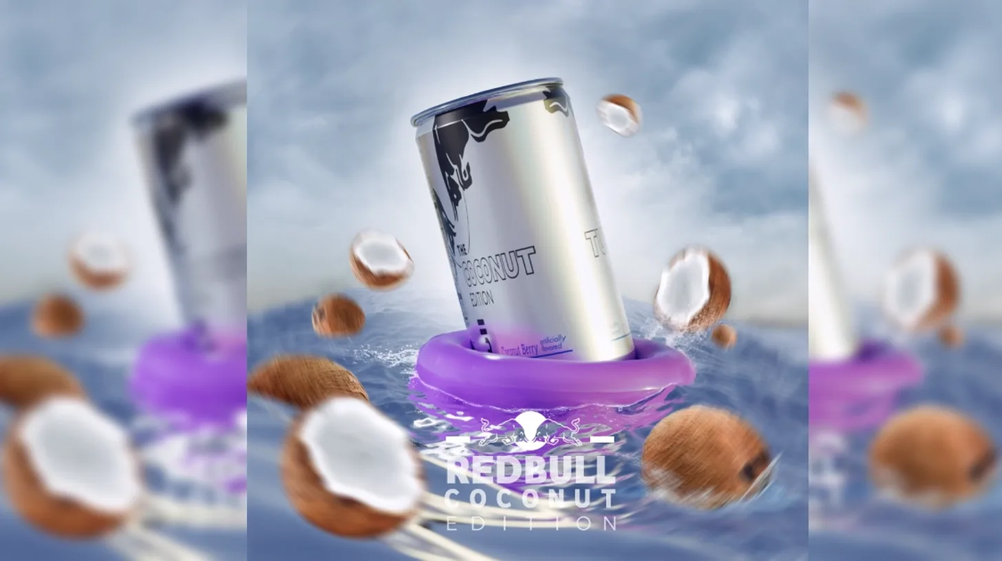 The white-can Coconut Edition, still on shelves despite the rumors — Red Bull Red Bull Coconut Edition can in a coconut-berry advertisement floating on a purple pool ring