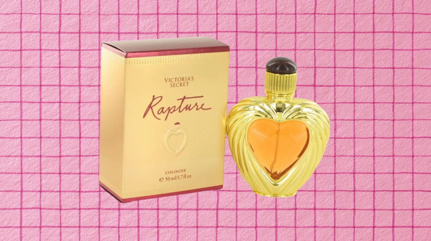 The discontinued Victoria's Secret Rapture cologne in a gold heart-shaped bottle beside its 50 ml box